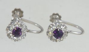A pair of silver and amethyst screw post earrings. Total weight 2.