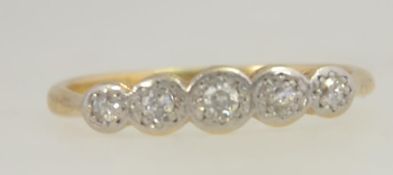 An 18ct gold and platinum ladies 5 stone diamond ring, the stones approx pnts. Size M / Weight 2.