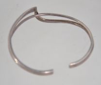 A 925 silver twin cuff bangle bracelet with wrap over twist decoration. Marked 925. Weight 11.8g.