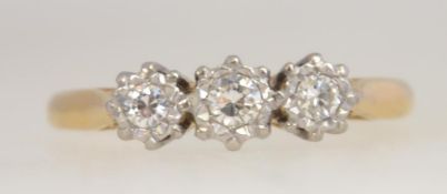 An 18ct gold, platinum and 3 stone diamond claw set vintage ring. The stones approx 25pnts. Size O.