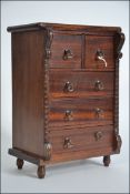 A 20th century Apprentice piece Scottish mahogany chest of drawers raised on turned legs with short