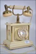 A retro / vintage rotary dial cradle telephone having a modern telephone connection H30cm