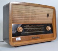 A vintage HMV Valve Radio walnut cased mid 20th century with knobs to front and mesh speaker atop.