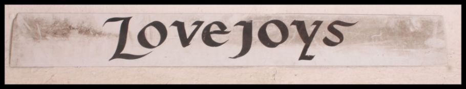 A retro 20th century metal enamel painted long rectangular sign for Lovejoys.