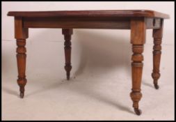 A 19th century mahogany wind out dining table of good quality having an extra leaf.