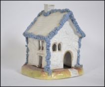 A fine moulded painted and gilded pastille burner in the Rockingham style dating to the 1840's,