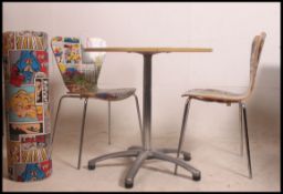A 20th century upcycled circular dining table and two matching chairs,