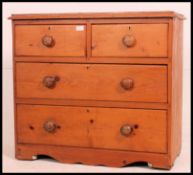 A Victorian pine chest of two short over two long drawers with knob handles on plinth base flared