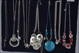 A collection of ten costume jewellery pendant necklaces of differing styles to include silver etc