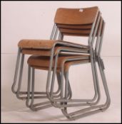 A set of 4 vintage ply panel bentwood Industrial hall chairs raised on tubular metal frames with