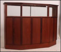 A 1970's retro large teak wood cocktail cabinet bar of angular form with teak body and top having