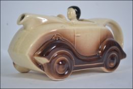 A very early , possibly Sadler but unmarked , teapot in the form of the racing car and driver ,