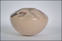 A 20th century laguna pottery jar of squat form with exhibition label ' mx ' inscribed to base De