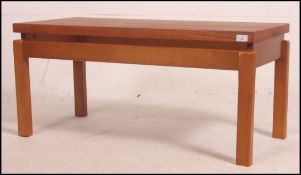 A vintage 1970's retro teak coffee table on ' floating ' wooden base of square form with