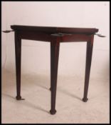 A vintage early 20th century square gaming / poker table having a flip over top with a brown baize