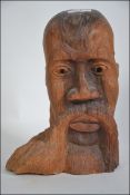 A 20th Century Oriental / African Carved Wooden Head by L Walters (the name inscribed to base) with