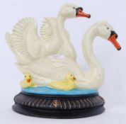 A decorative 20th century painted metal doorstep in the form of swans.
