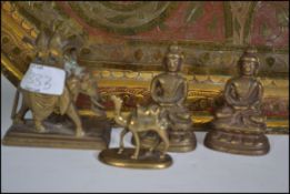 A brass heavily patterned octagonal tray of large form along with 4 small asiatic cast brass pieces
