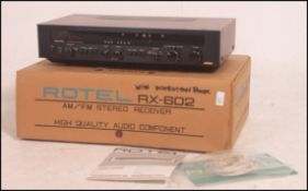 A 1970's vintage Rotel RX602 AM/FM stereo receiver being boxed complete with instructions.