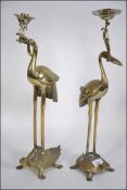 A pair of 20th Century Oriental brass candle holders in the form of Tsuru and Kames (cranes and
