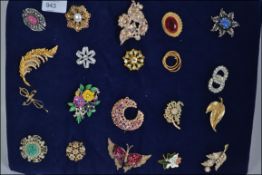 A collection of twenty costume brooches of differing styles to include enamel,