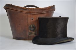 A Victorian leather hat box complete with top hat being marked for Meyrick of Falmouth, Cornwall.
