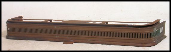 Brass trimmed cast fire place fender of medium proportion.