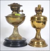 Two early 20th century brass oil lamps. Measures: 32cms high.