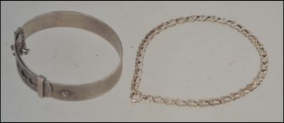A silver machine turned christening bangle together with a silver link bracelet. 15.