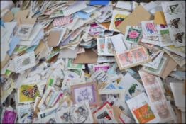A large collection of loose stamps (some on envelopes ) kiloware,