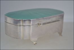 A very good silver casket with engine turned enamel hinged lid in green .