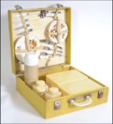 A vintage mid century retro yellow Brexton picnic hamper complete with the contents to include