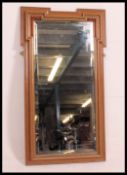 A Victorian oak Armorial wall mirror having squared flash corners with bevelled mirror glass to
