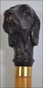 A 20th century walking cane having a Setter dog top,