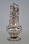 A silver hallmarked sugar sifter having pierced top bearing hallmarks for London by Haseler