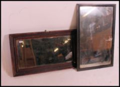 Two early 20th century framed mirrors, both mirrors being distressed with foxing and pitting,