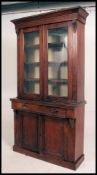 A Victorian mahogany library bookcase cabinet with detachable moulded cornice above a pair of