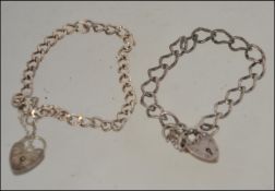 A pair of silver hallmarked silver curb bracelets both with heart lockets,