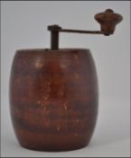 A rare mid 19th century treen pepper mill / grinder in the form of a barrel with handle to top