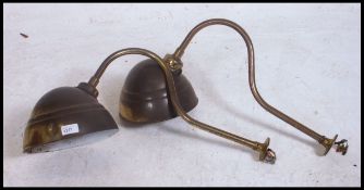 A pair of vintage early 20th century brass swan neck wall / sign lights having brass directional