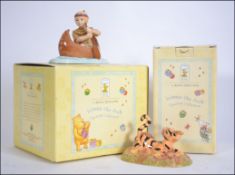 A Royal Doulton Winnie The Pooh figurine complete in the box.