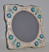 A silver and enamel set easel picture frame H8cm.