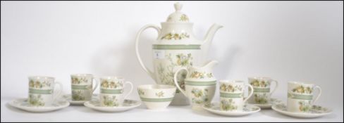 A Royal Doulton 6 person coffee service in the Tonkin TC 1107 pattern to include 6 coffee cans and