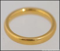 A 22ct gold band ring bearing London hallmarks , date letter B. Total weight 4.6g.
