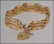A 9ct hallmarked box chain bracelet 16cm long having an heart shaped locket with London assay marks.