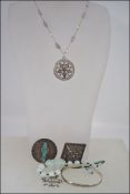 White metal brooch with jade like figure to centre,