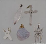 A collection of 5 silver 925 / sterling marked necklace pendants to include spider, wave, crucifix,
