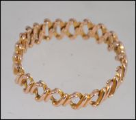 A designer yellow metal (tests for 9ct gold ) articulated expanding bracelet with expanding links