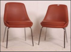 A pair of 1960's vintage / retro Ben type dining chairs having the original burgandy vinyl