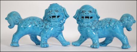 A pair of 20th century Chinese models of temple dogs / u dogs on plinths,